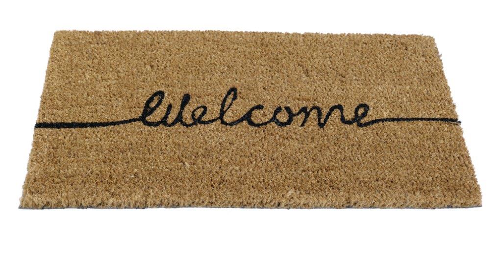 A rectangular coir doormat with black PVC backing, featuring the word 'Welcome' in black script.