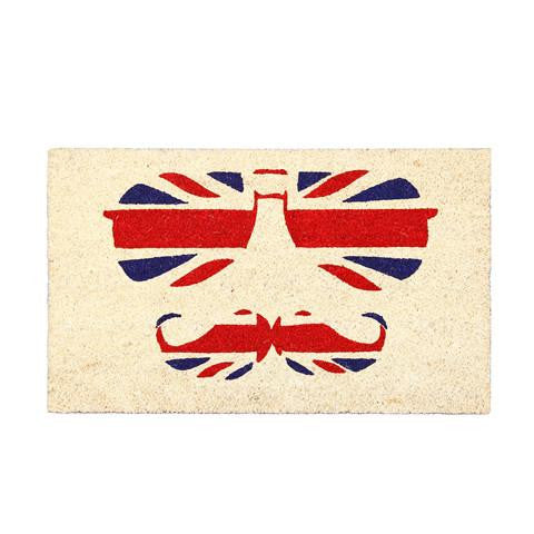 Rectangular coir door mat with a printed design featuring a British flag and a stylised moustache and sunglasses on the bottom half, predominantly red and blue with a white border.
