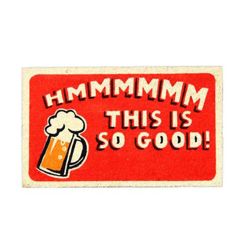 Rectangular coir door mat with a humorous printed design featuring the phrase 'Hmmmm This is So Good!' and an illustration of a beer mug.