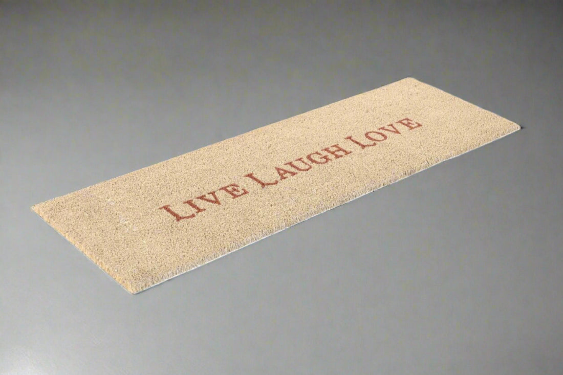 A natural beige coir door mat with the text 'Live Laugh Love' printed in a darker beige color.