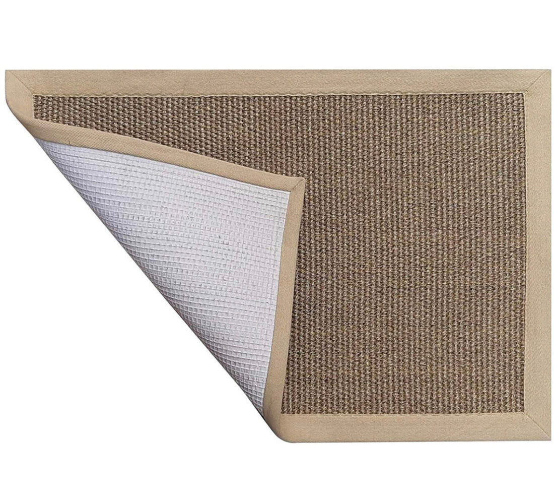 
                      
                        Sisal rug with a textured surface and border on a white background
                      
                    