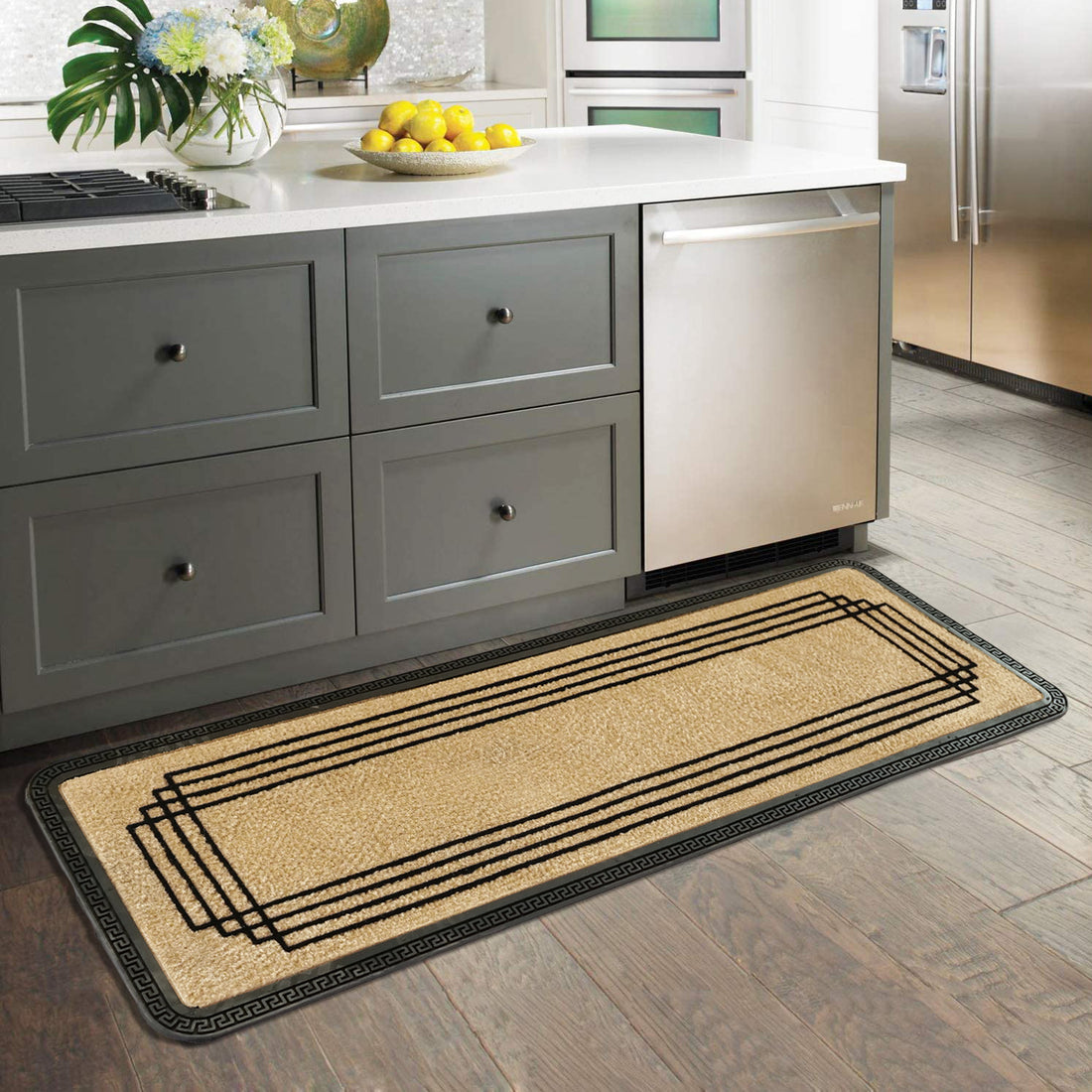 A beige kitchen runner mat with a geometric pattern laid out on a wooden floor, with a black border and decorative elements visible in the background.
