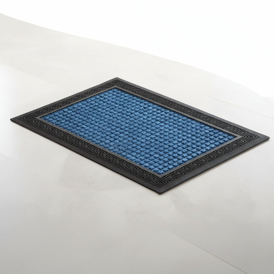 A blue rectangular bath mat with a solid pattern, placed on a tiled floor.