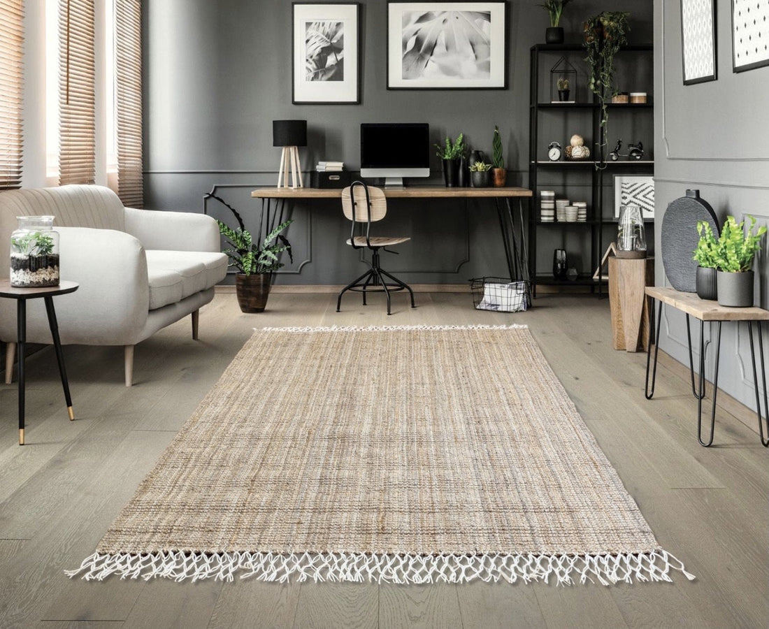 Living room with a woven jute rug, sofa, and office desk.