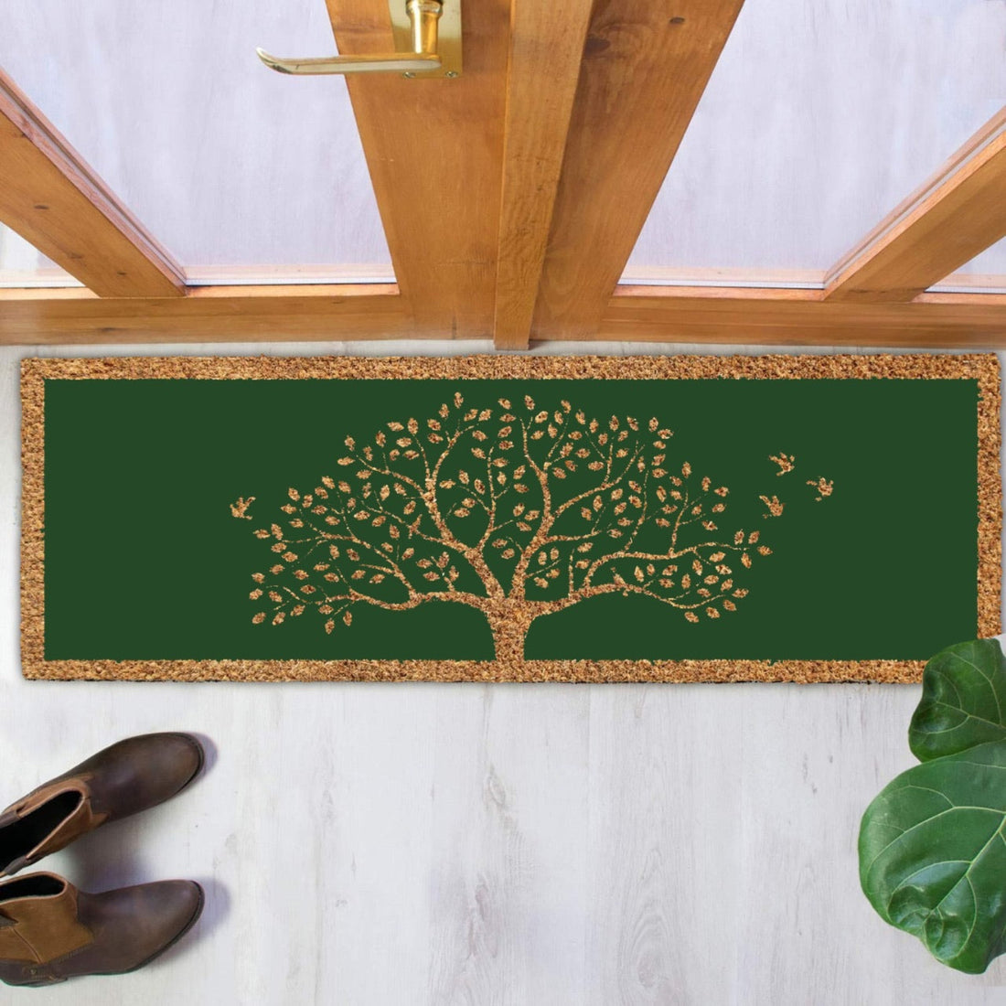 
                      
                        Decorative coir doormat with tree design on a white floor next to a wooden door.
                      
                    