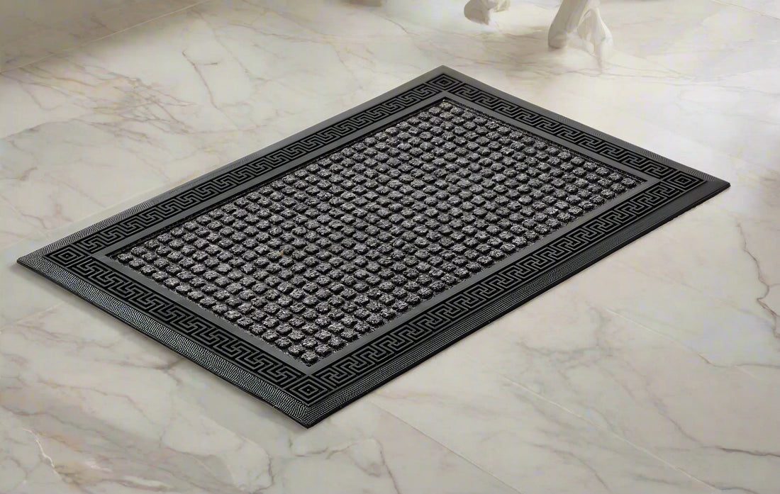 
                      
                        A grey, rectangular OnlyMat bath mat made of polypropylene with an anti-slip design, placed on a tiled floor.
                      
                    