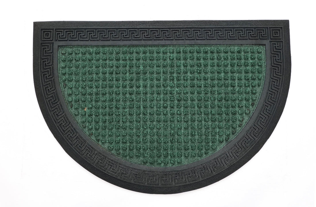 
                      
                        A green rectangular doormat with an intricate geometric pattern and a decorative border.
                      
                    