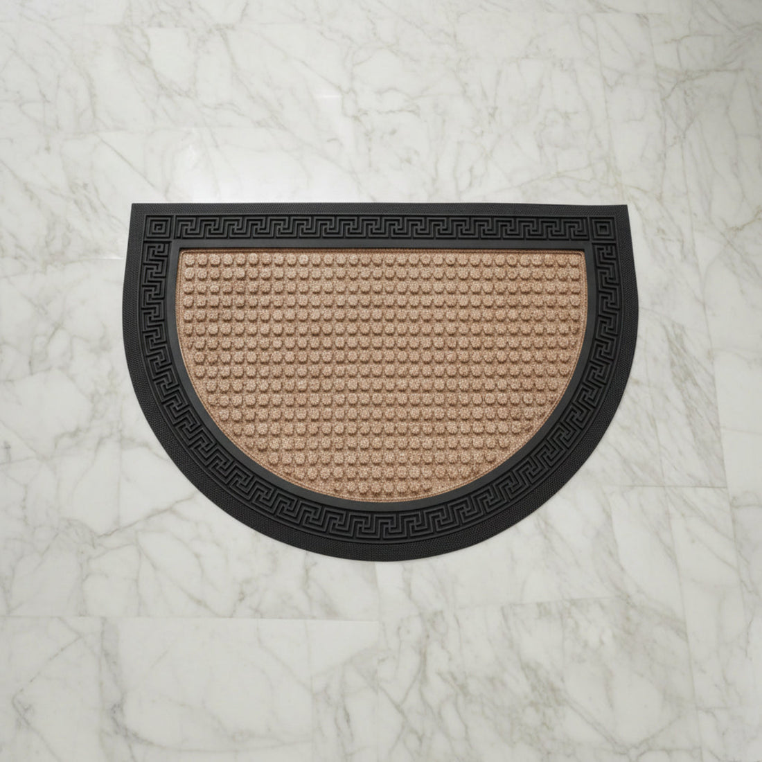 A beige and black semi-circular bath mat with an anti-slip design, placed on a tiled floor.