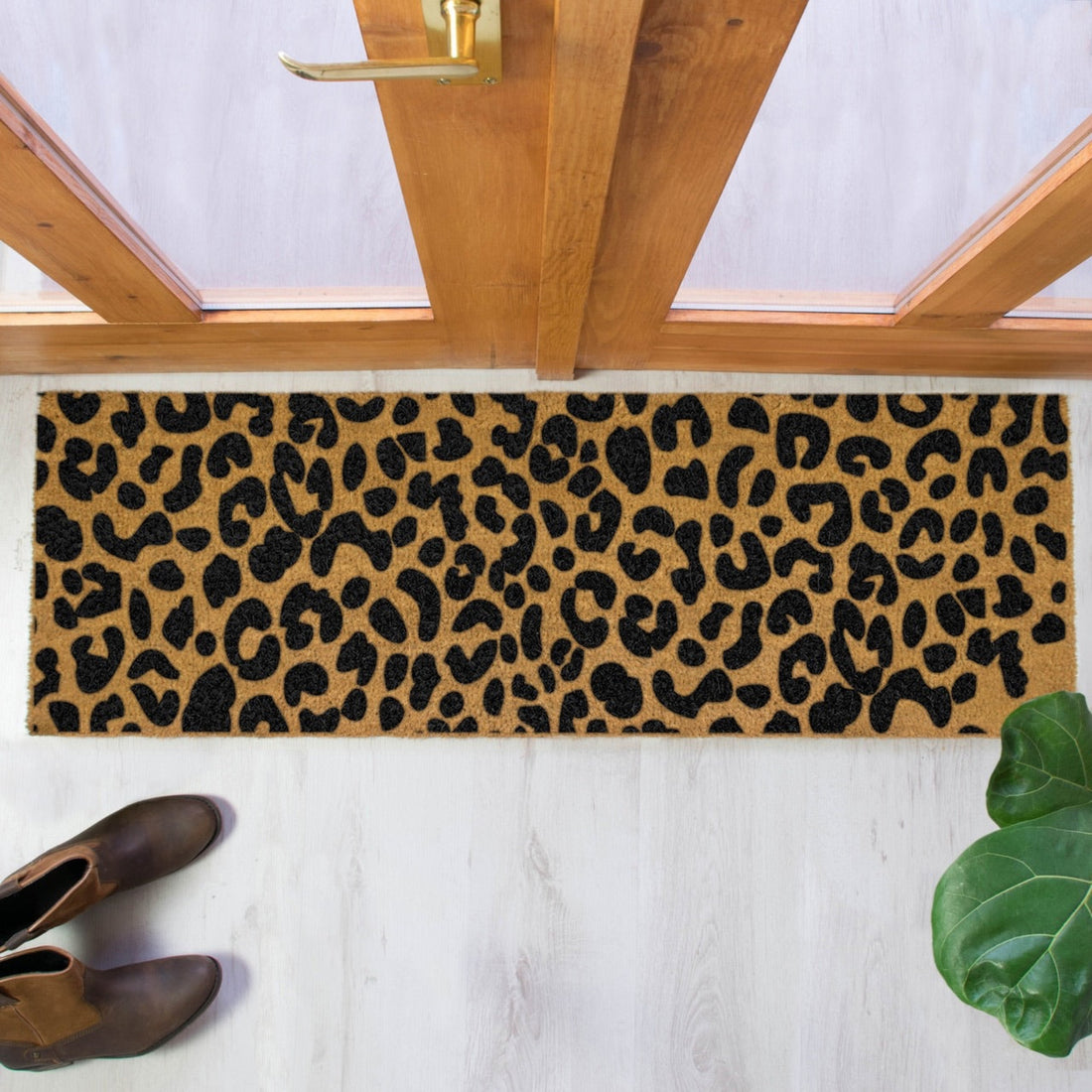 
                      
                        Doormat with leopard print pattern in front of a wooden door.
                      
                    