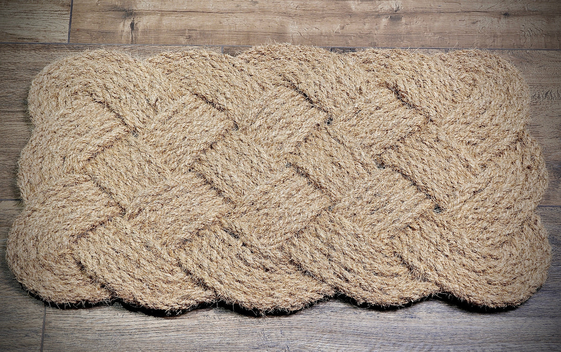 
                      
                        Woven coir rope doormat on a wooden floor
                      
                    
