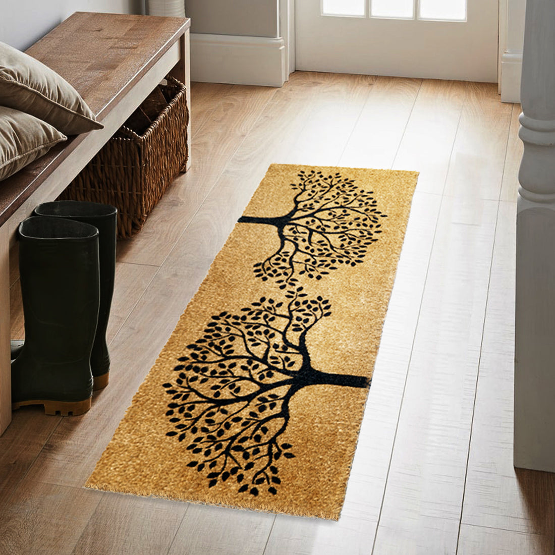 
                      
                        An oblong doormat with a printed natural coir surface featuring a tree of life design, placed on a wooden floor in a home environment.
                      
                    