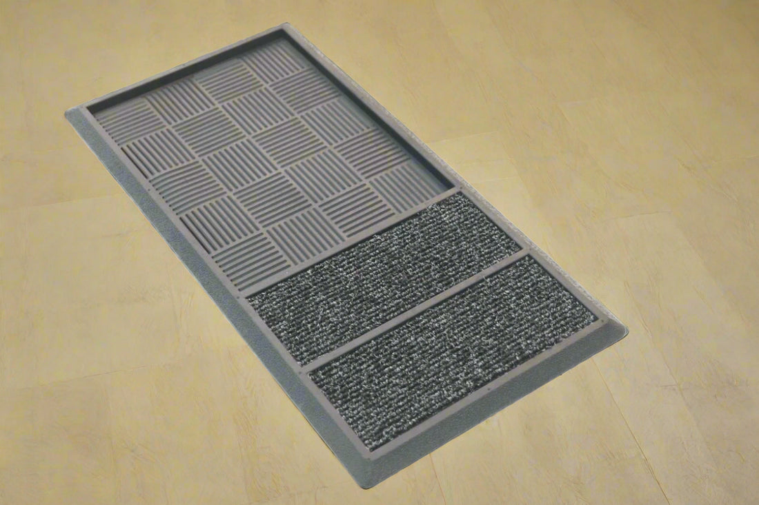 A black rubber tray mat with geometric patterns, featuring two polypropylene inserts for shoe drying.