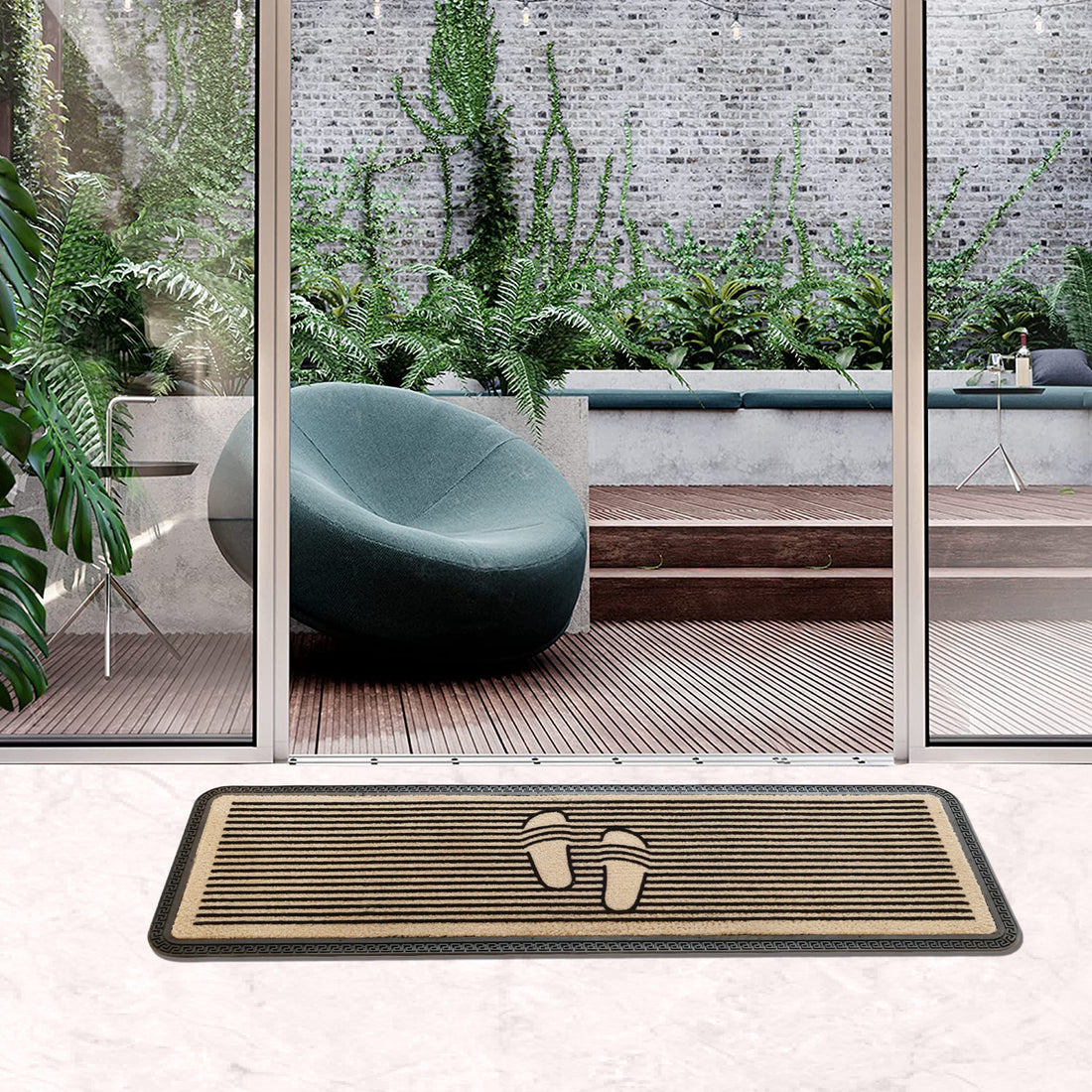 A beige, solid-patterned polypropylene doormat with a non-skid rubber backing, placed on a floor with a clear view of a modern indoor garden and seating area.