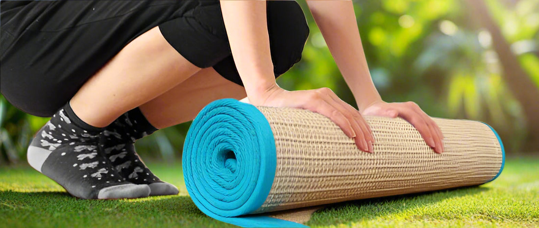 A rolled-up yoga mat with a beige jute base and a light blue cotton border, displayed on the floor.